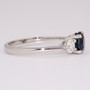 Platinum round cut teal sapphire and round brilliant cut diamond ring side