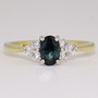 18ct gold and platinum oval cut teal sapphire and six round brilliant cut diamond ring