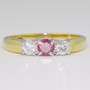 18ct yellow and white gold diamond trilogy ring with treated fancy deep purplish pink centre diamond