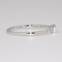 Platinum rubover-set sapphire ring with diamond-set shoulders side