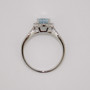 Platinum oval cut aquamarine and round brilliant cut diamond halo ring with open diamond-set shoulders top