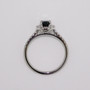 Platinum oval cut teal sapphire and round brilliant cut diamond cluster ring with diamond-set shoulders top