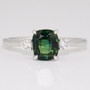 Platinum rectangular cushion cut green sapphire and round brilliant cut diamond ring