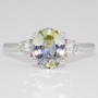 Platinum oval cut blue and yellow parti sapphire and round brilliant cut diamond ring