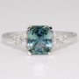 Platinum unheated radiant cut teal sapphire and round brilliant cut diamond ring