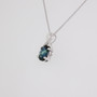 9ct white gold oval cut teal sapphire and diamond swirl pendant side