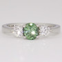 Platinum round cut green sapphire and round brilliant cut diamond ring Platinum round cut green sapphire and round brilliant cut diamond ring