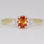 18ct gold and platinum oval cut orange sapphire and six round brilliant cut diamond ring