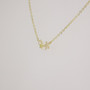 9ct gold plain and CZ-set star necklace side