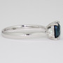 Platinum unheated cushion cut teal sapphire and round brilliant cut diamond ring side