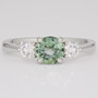 Platinum round cut green sapphire and round brilliant cut diamond ring