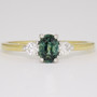 18ct gold oval cut teal sapphire and round brilliant cut diamond ring