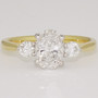 18ct gold and platinum ring with a GIA certificated oval cut diamond and two round brilliant cut diamonds