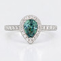 Platinum pear cut unheated Madagascan teal sapphire and round brilliant cut diamond halo ring with diamond-set shoulders