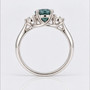 Platinum unheated oval cut teal sapphire and round brilliant cut diamond ring
