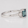 Platinum unheated princess cut teal sapphire and round brilliant cut diamond ring side