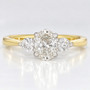 18ct gold and platinum ring with a GIA certificated oval cut diamond and two round brilliant cut diamonds