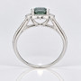Platinum cushion cut Madagascan teal sapphire and round brilliant cut diamond halo ring with diamond-set shoulders profile