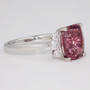 Unique platinum cushion cut pink ziron and graduated round brilliant cut diamond ring side