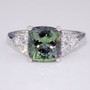 Platinum cushion cut green tanzanite and round brilliant cut diamond ring