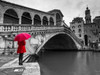 A woman in a red dress holding red umbrella and standing next to the Rialto bridge, Venice, Italy Poster Print by  Assaf Frank - Item # VARPDXAF20130409237C03