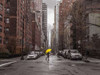 Tourist with yellow umbrella on street of Manhattan, New York Poster Print by  Assaf Frank - Item # VARPDXAF20160116084C02