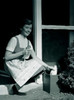 Young woman collecting milk bottles outside home Poster Print - Item # VARSAL255417302