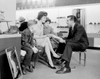 Shop assistant showing women's shoe to mother with son and daughter Poster Print - Item # VARSAL255417915A