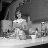 Woman reading cookbook in kitchen Poster Print - Item # VARSAL25527910