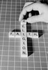 Mans hand making religious cross from scrabble pieces Poster Print - Item # VARSAL255421403