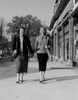 Two young woman walking and holding hands Poster Print - Item # VARSAL255422128