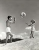 Young couple playing with a beach ball on the beach Poster Print - Item # VARSAL2552668