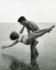 Young man carrying young woman on beach Poster Print - Item # VARSAL2555972