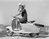Portrait of cheerful young woman sitting on scooter Poster Print - Item # VARSAL255416335