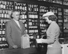 Young woman making a purchase at a liquor store Poster Print - Item # VARSAL25543591