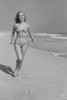 Young woman in bikini walking on beach Poster Print - Item # VARSAL255422733