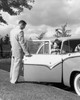 Young man opening the door of a car for a teenage girl Poster Print - Item # VARSAL2557542