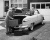 Side profile of a young man loading luggage into a car trunk Poster Print - Item # VARSAL2554990