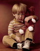 Portrait of a boy holding a teddy bear and looking displeased Poster Print - Item # VARSAL3811362903