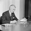 Businessman writing behind desk Poster Print - Item # VARSAL255422409