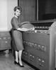 Portrait of a businesswoman holding a document beside a filing cabinets Poster Print - Item # VARSAL25528006B