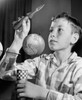 Close-up of a boy holding a model of a rocket Poster Print - Item # VARSAL2555267