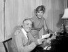 Senior man giving check to woman Poster Print - Item # VARSAL255416294