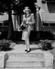 Young elegant woman standing in front of house Poster Print - Item # VARSAL255422351