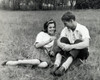 Young couple sitting in a park smiling Poster Print - Item # VARSAL2553872