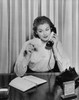 Businesswoman talking on the telephone and holding a bill Poster Print - Item # VARSAL25524821