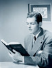 Businessman reading bible in office Poster Print - Item # VARSAL255417267