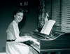 Portrait of young woman playing piano at home Poster Print - Item # VARSAL255417295
