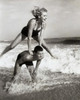 Young couple playing leapfrog in surf Poster Print - Item # VARSAL2558784