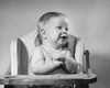 Baby sitting in a high chair and smiling Poster Print - Item # VARSAL2559711